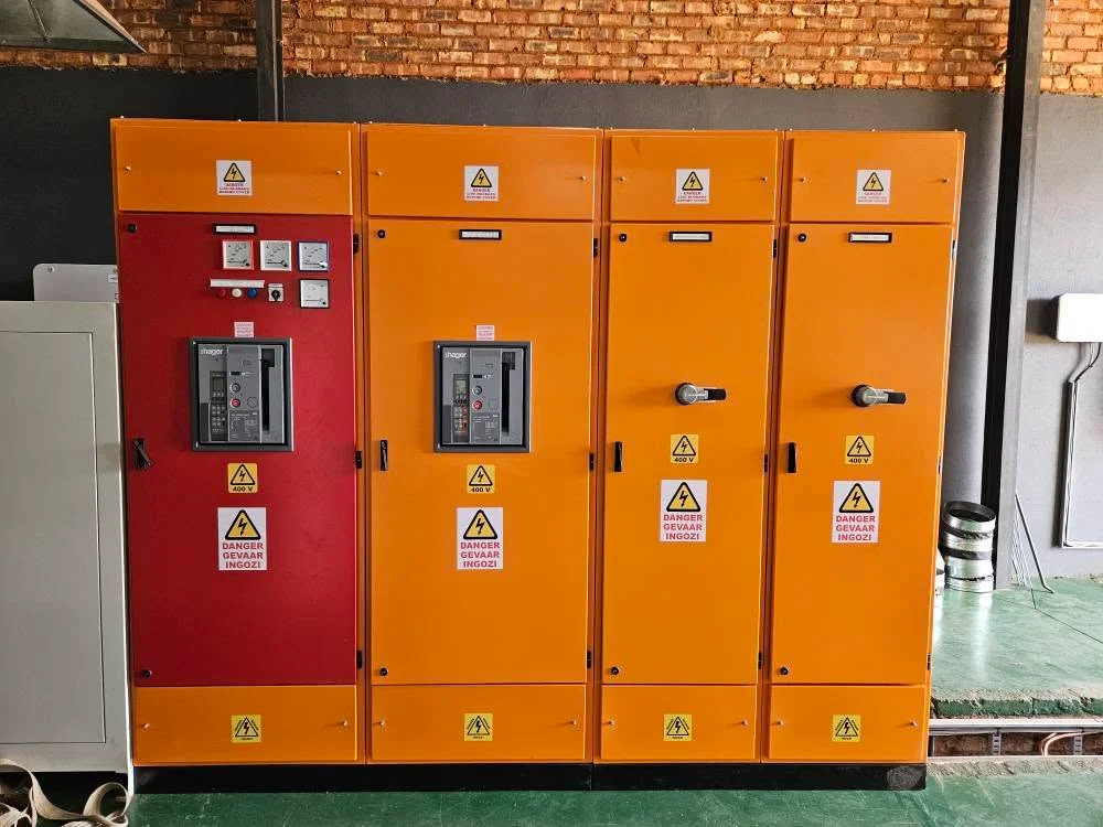 Orange and red main distribution switchboard with Hager circuit breakers and 400 volt warning labels